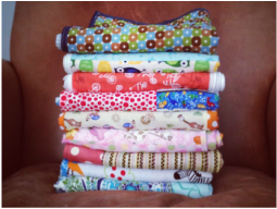 Photograph of a stack of quilts.